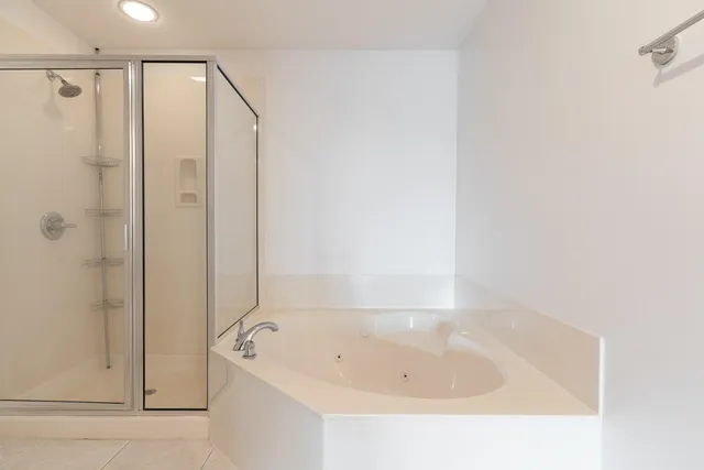 an empty room with a chandelier fan