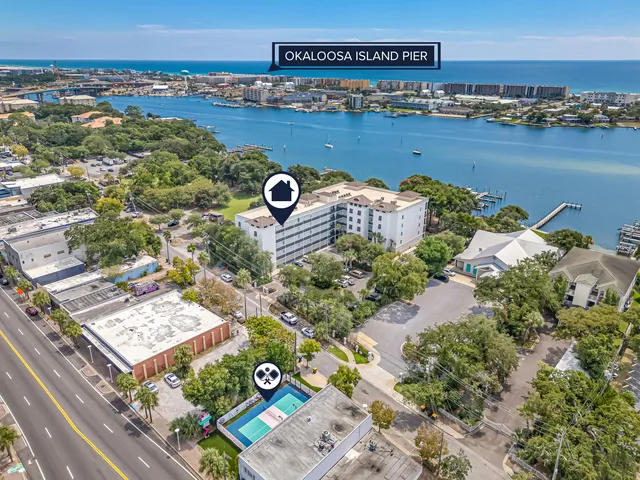 an aerial view of a house with a yard and lake view
