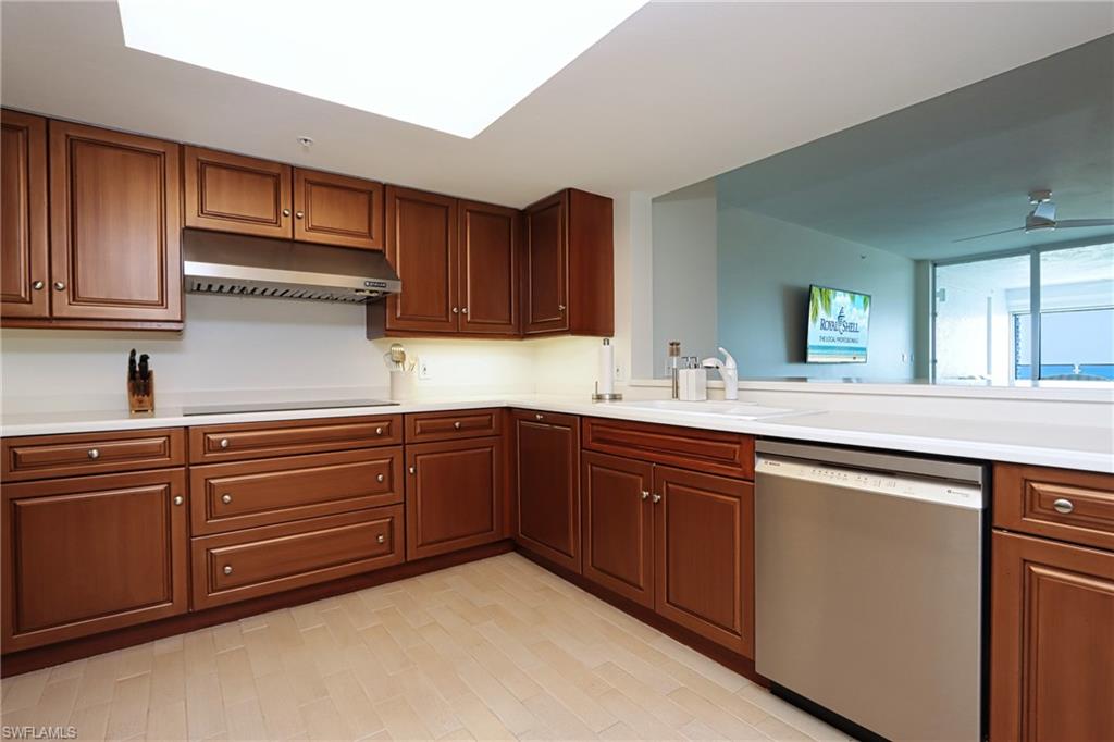 60 Seagate Drive, Unit 704 Naples, FL 34103 - Photo 11 of 28 a kitchen with granite countertop cabinets stainless steel appliances and a sink