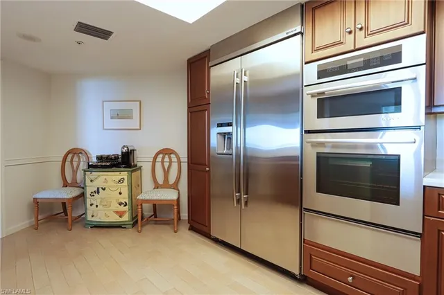 a kitchen with a refrigerator and table