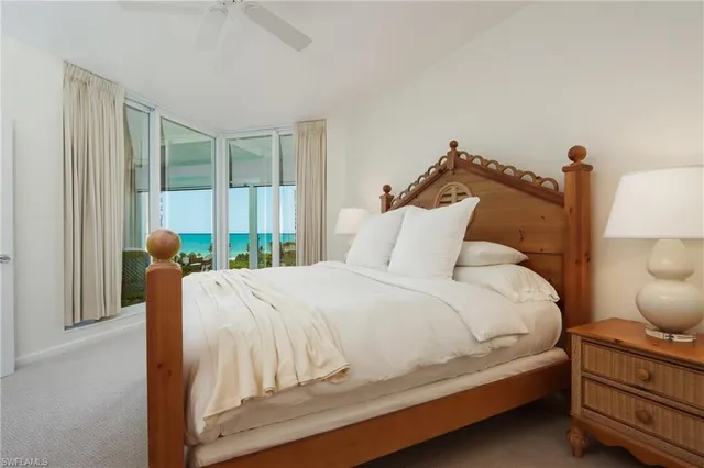 a bedroom with a bed and large window