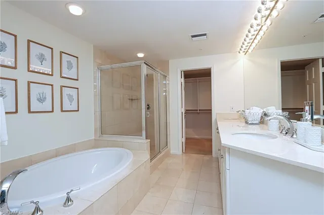 a bathroom with a tub a sink and mirror