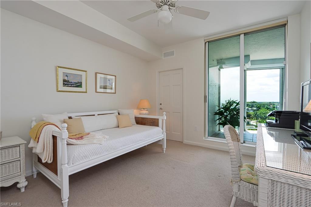 60 Seagate Drive, Unit 704 Naples, FL 34103 - Photo 19 of 28 a bedroom with furniture and a large window