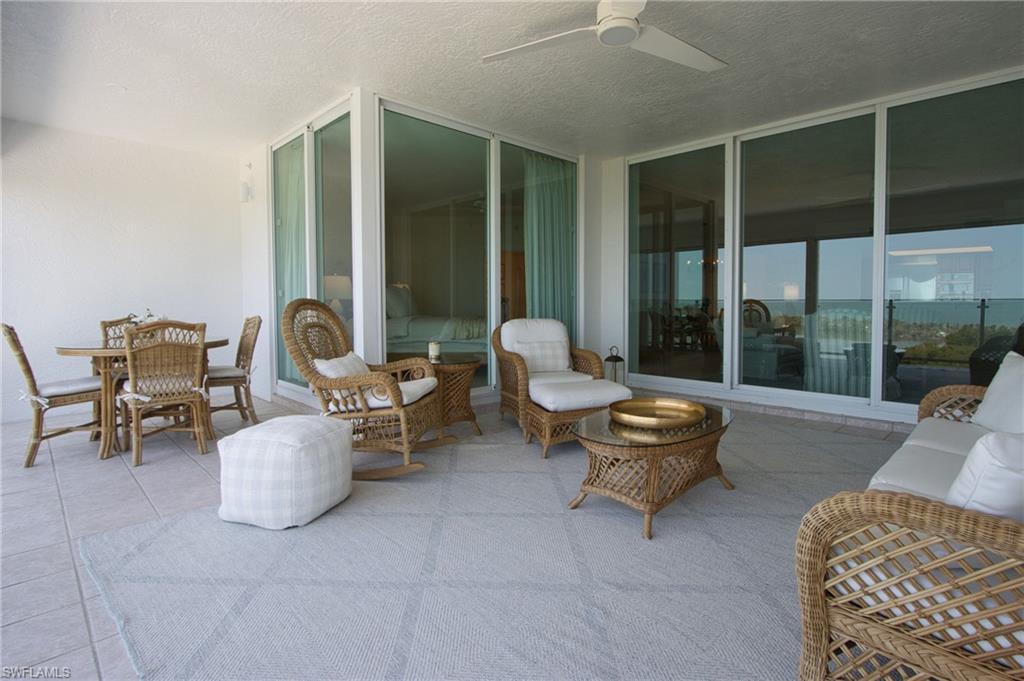 60 Seagate Drive, Unit 704 Naples, FL 34103 - Photo 4 of 28 a living room with furniture and a large window
