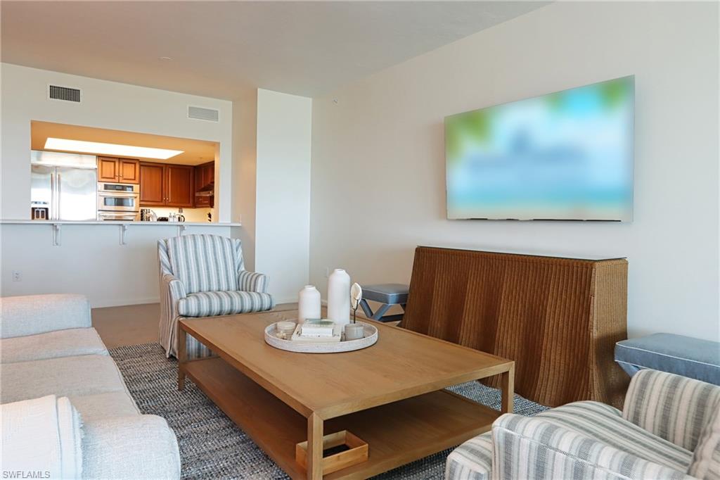 60 Seagate Drive, Unit 704 Naples, FL 34103 - Photo 6 of 28 a view of a dining room with furniture