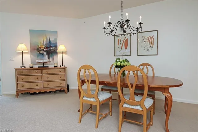 a dining room with furniture and chandelier