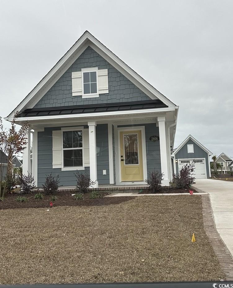 2816 Rowyn Street Longs, SC 29568 - Photo 1 of 1 View of front facade featuring a porch, a garage, and driveway