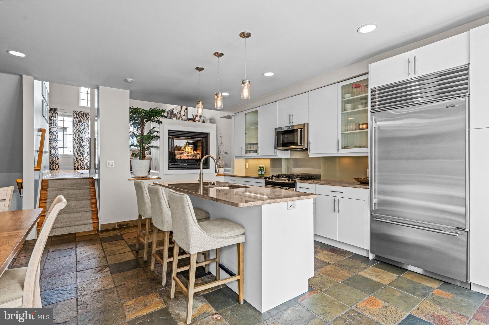 116 Quarry Street Philadelphia, PA 19106 - Photo 21 of 57 a kitchen with microwave a refrigerator and chairs