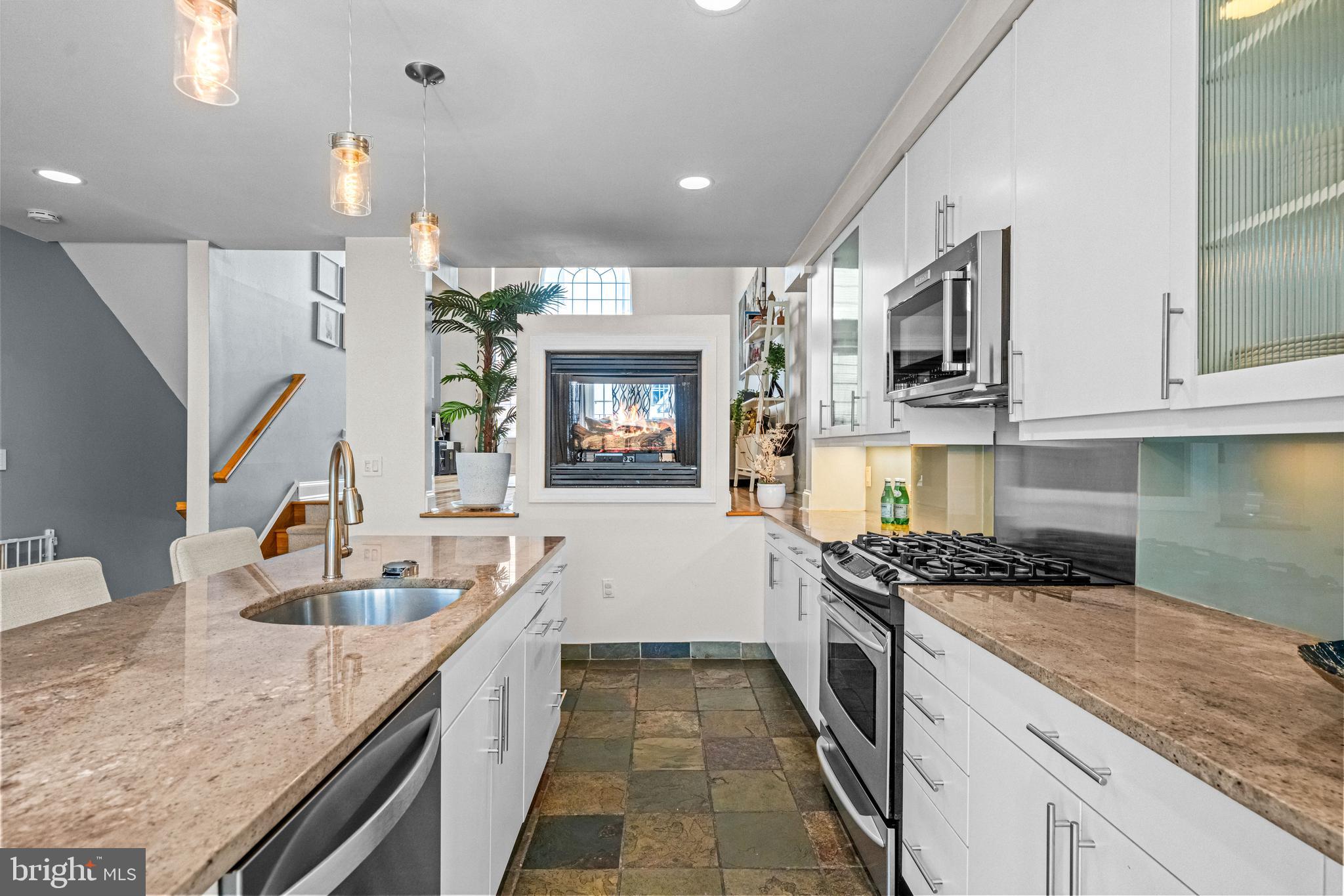 116 Quarry Street Philadelphia, PA 19106 - Photo 23 of 57 a kitchen with granite countertop a sink stove and cabinets