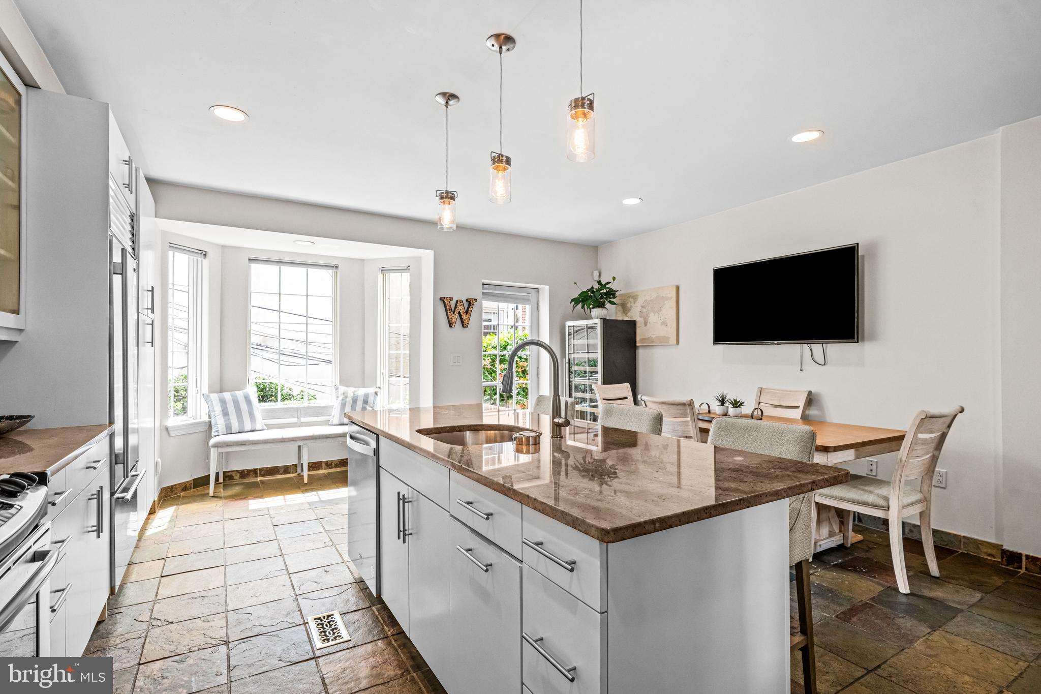 116 Quarry Street Philadelphia, PA 19106 - Photo 24 of 57 a large kitchen with granite countertop a sink and a stove top oven
