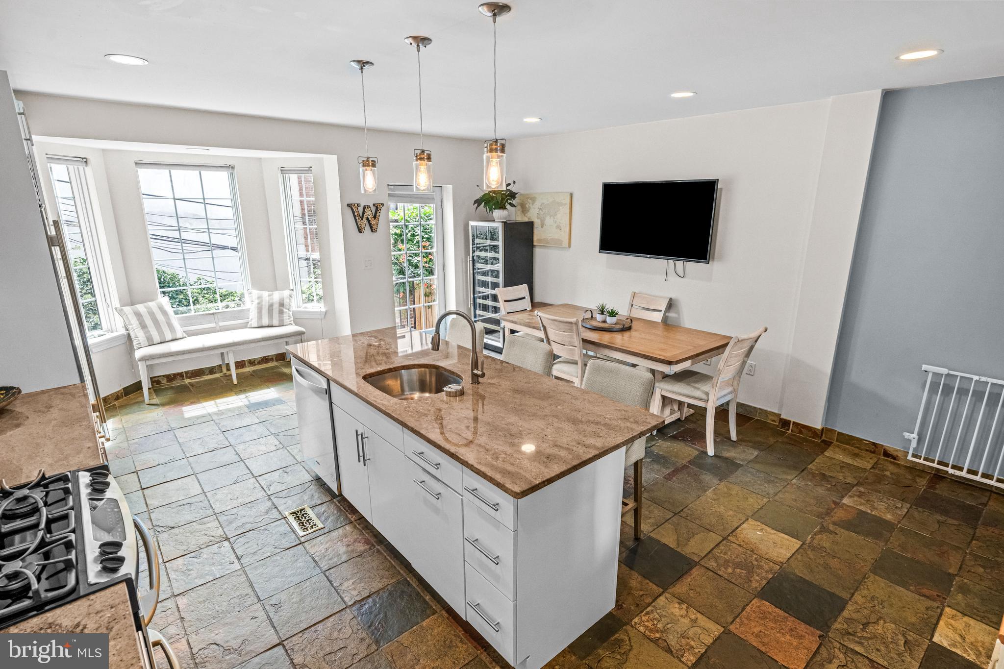 116 Quarry Street Philadelphia, PA 19106 - Photo 29 of 57 a kitchen with a stove a sink a counter top space and living room view