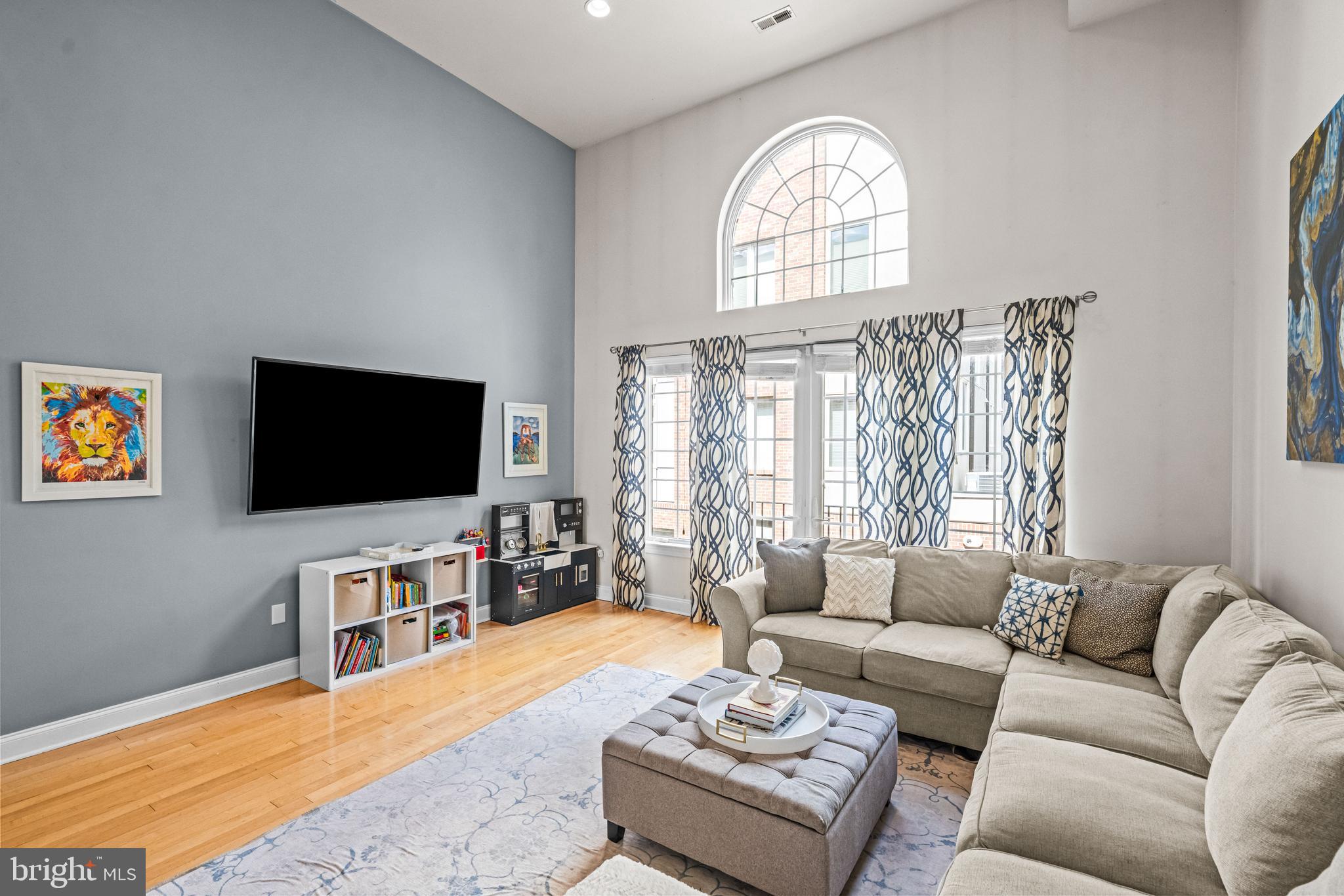 116 Quarry Street Philadelphia, PA 19106 - Photo 33 of 57 a living room with furniture a flat screen tv and a large window
