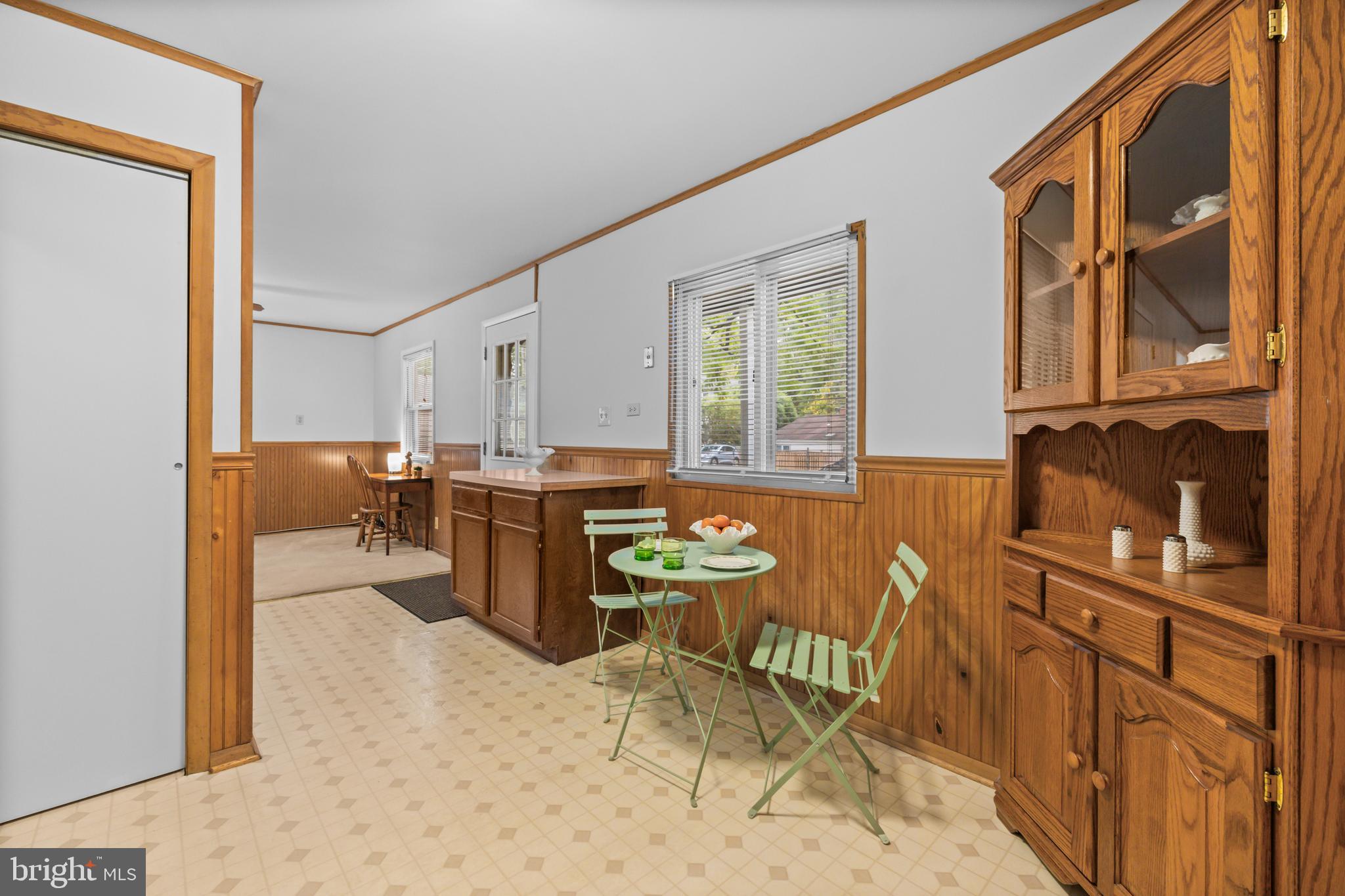 4 Russell Road Cabin John, MD 20818 - Photo 17 of 56 a kitchen with stainless steel appliances kitchen island granite countertop a refrigerator a stove and a dining table with wooden cabinet