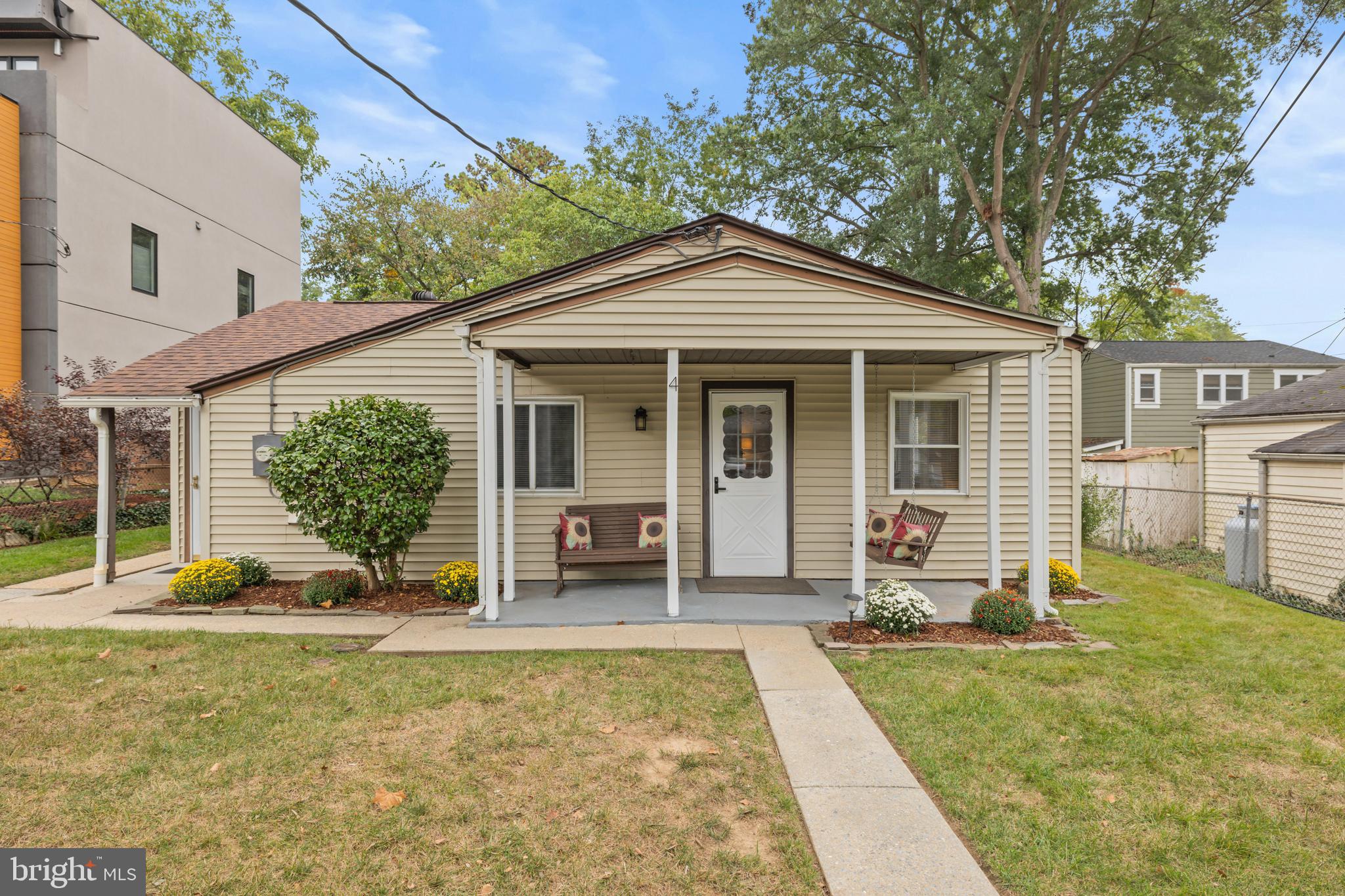 4 Russell Road Cabin John, MD 20818 - Photo 2 of 56 a view of a house with backyard sitting area and garden