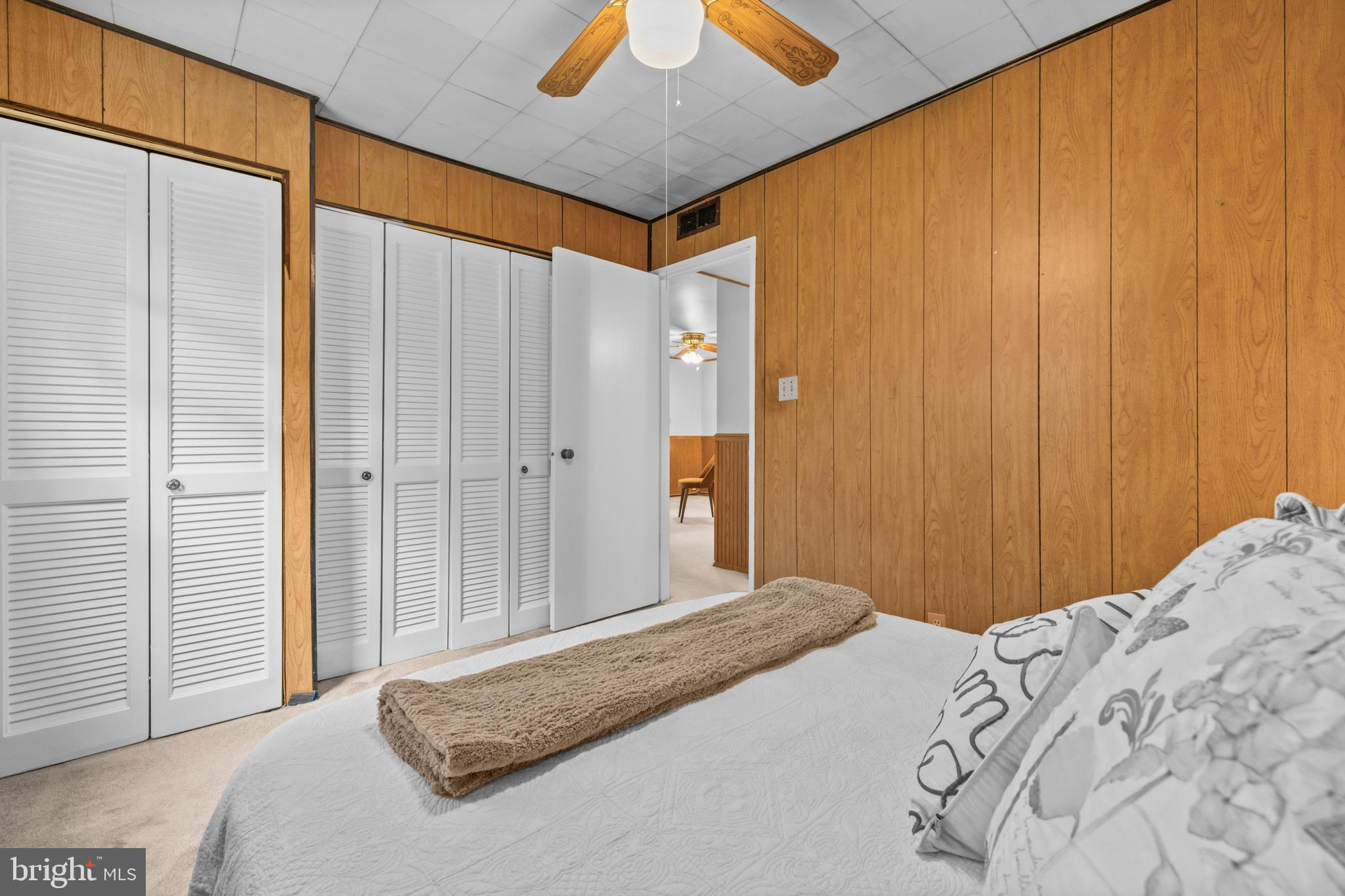 4 Russell Road Cabin John, MD 20818 - Photo 22 of 56 a bedroom with a bed and a chandelier