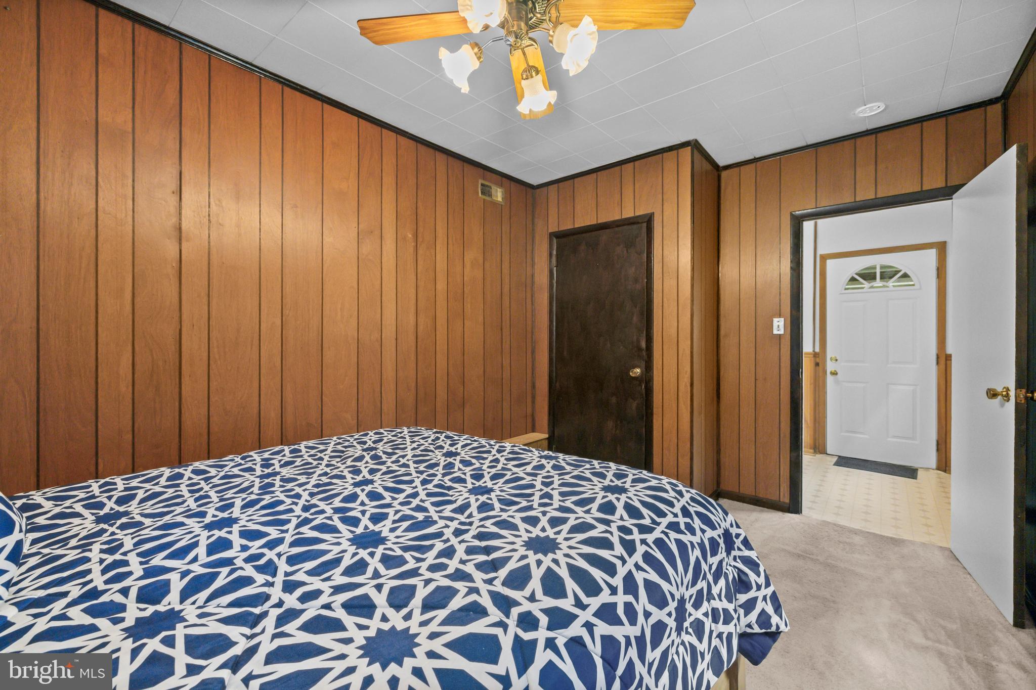 4 Russell Road Cabin John, MD 20818 - Photo 25 of 56 a bedroom with a bed and a lamp on dresser