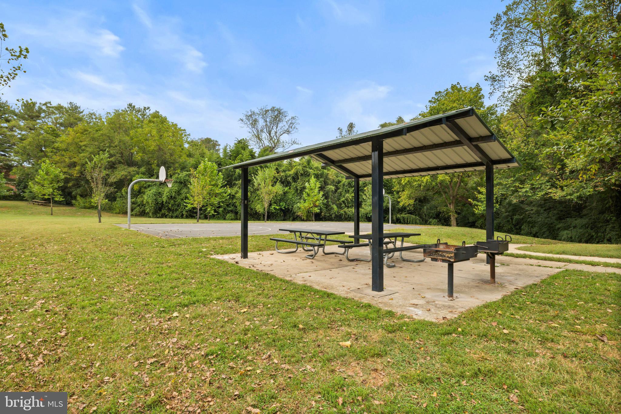 4 Russell Road Cabin John, MD 20818 - Photo 48 of 56 a view of a swimming pool with a bench and trees