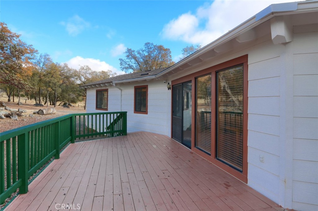 32786-32762 Road 221 North Fork, CA 93643 - Photo 31 of 73 a view of a roof deck with wooden floor and fence