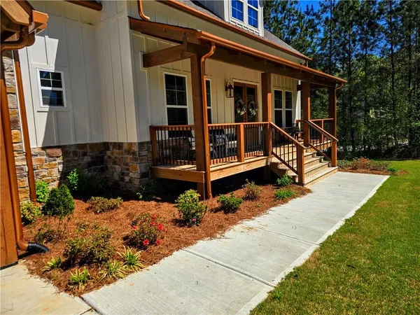 a view of outdoor space with wooden floor
