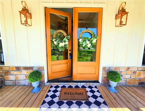 a view of a hallway with wooden floor and a living room