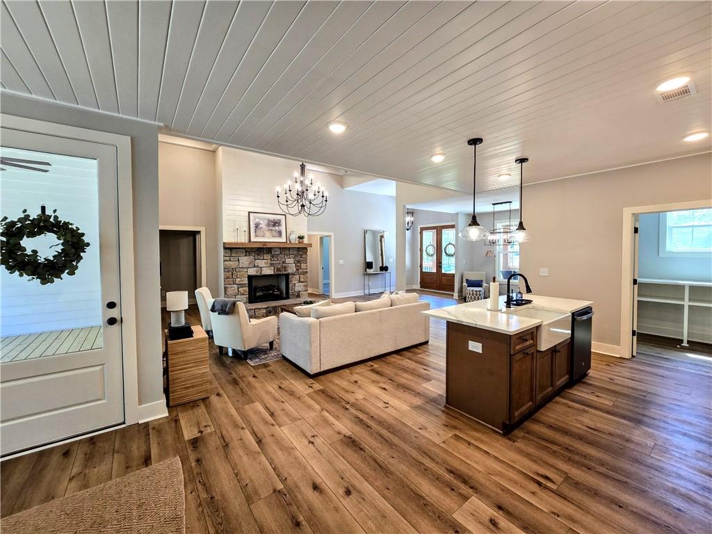 136 Rainey Road Temple, GA 30179 - Photo 27 of 75 a large living room with stainless steel appliances kitchen view and wooden floor