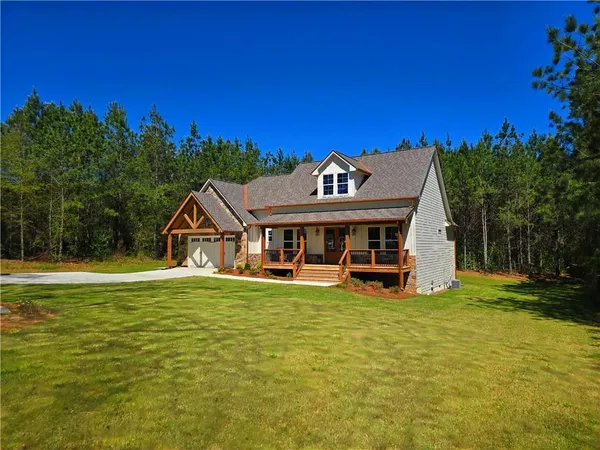 a view of a house with backyard porch and sitting area