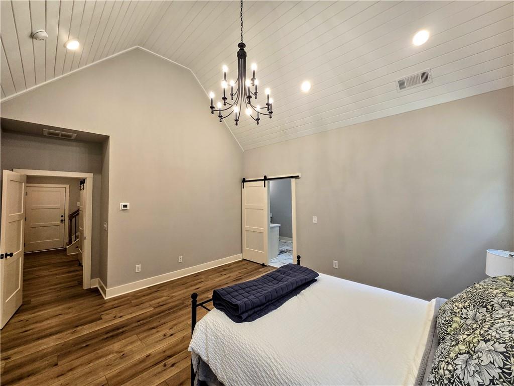 136 Rainey Road Temple, GA 30179 - Photo 36 of 75 a bedroom with a bed and wooden floor