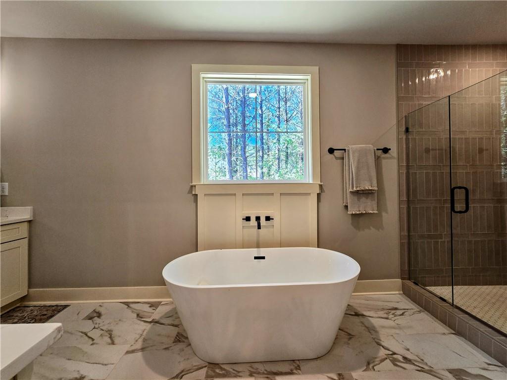 136 Rainey Road Temple, GA 30179 - Photo 38 of 75 a bathroom with a bathtub and shower
