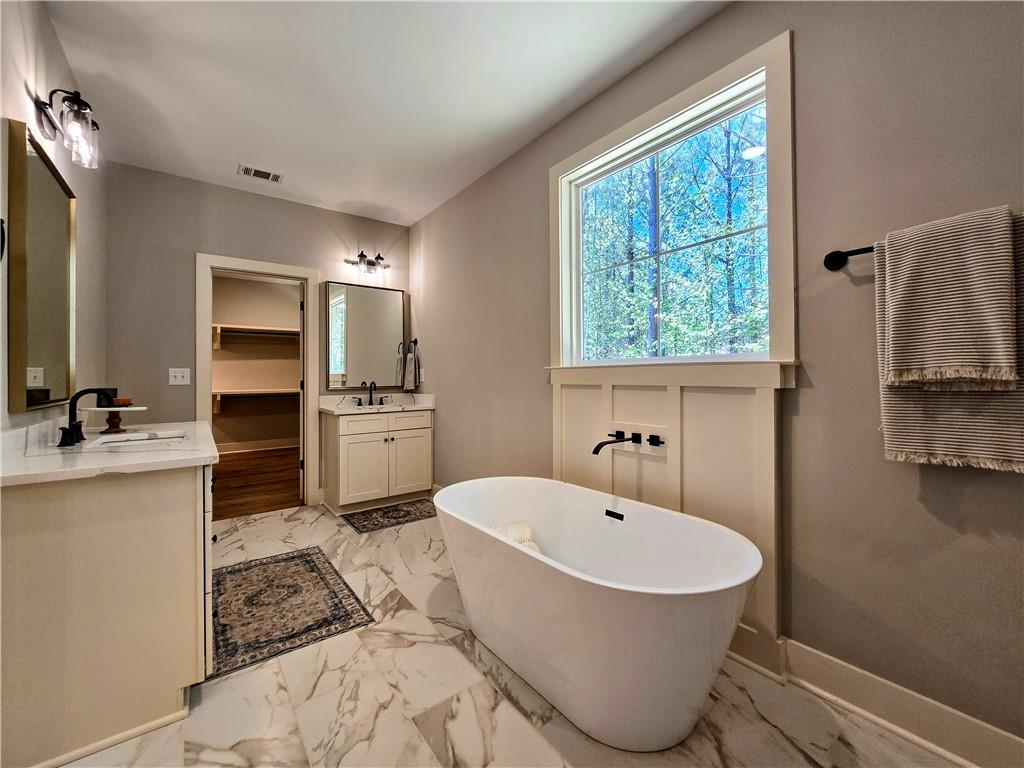136 Rainey Road Temple, GA 30179 - Photo 39 of 75 a bathroom with a tub sink and mirror