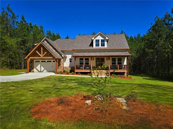 a view of a house with wooden walls and wooden fence