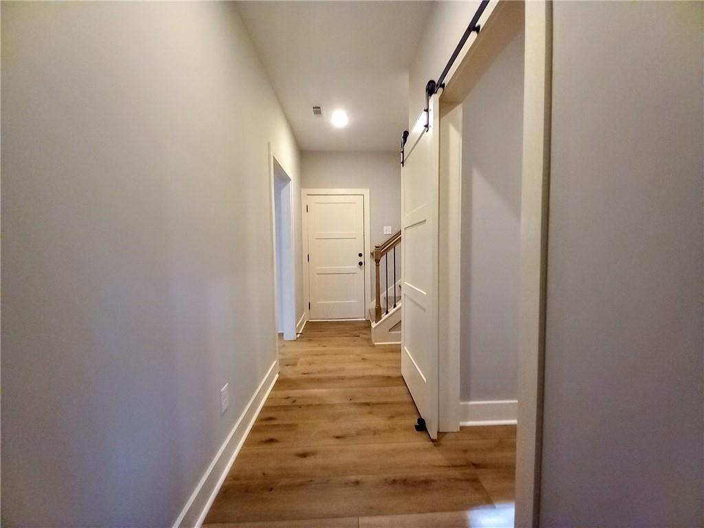136 Rainey Road Temple, GA 30179 - Photo 44 of 75 a view of a hallway with wooden floor and a living room