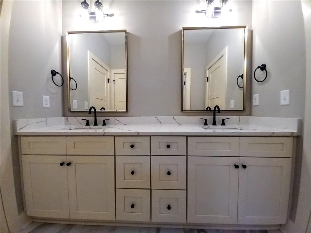 136 Rainey Road Temple, GA 30179 - Photo 54 of 75 a bathroom with double vanity sink and a mirror