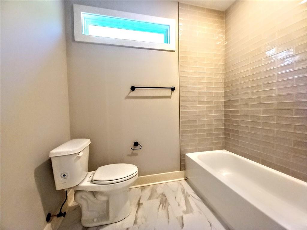 136 Rainey Road Temple, GA 30179 - Photo 55 of 75 a bathroom with a toilet and a bathtub