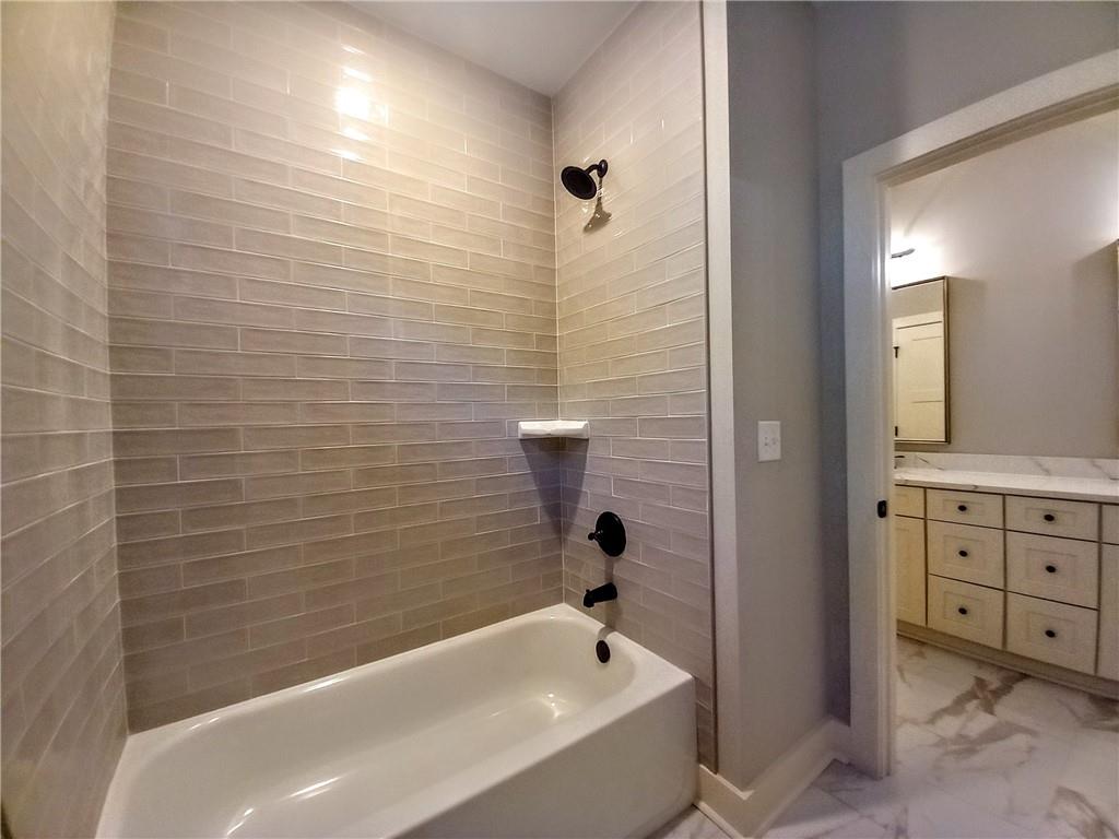 136 Rainey Road Temple, GA 30179 - Photo 56 of 75 a bathroom with a bathtub and shower