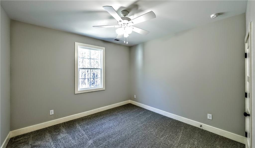 136 Rainey Road Temple, GA 30179 - Photo 57 of 75 an empty room with windows and fan