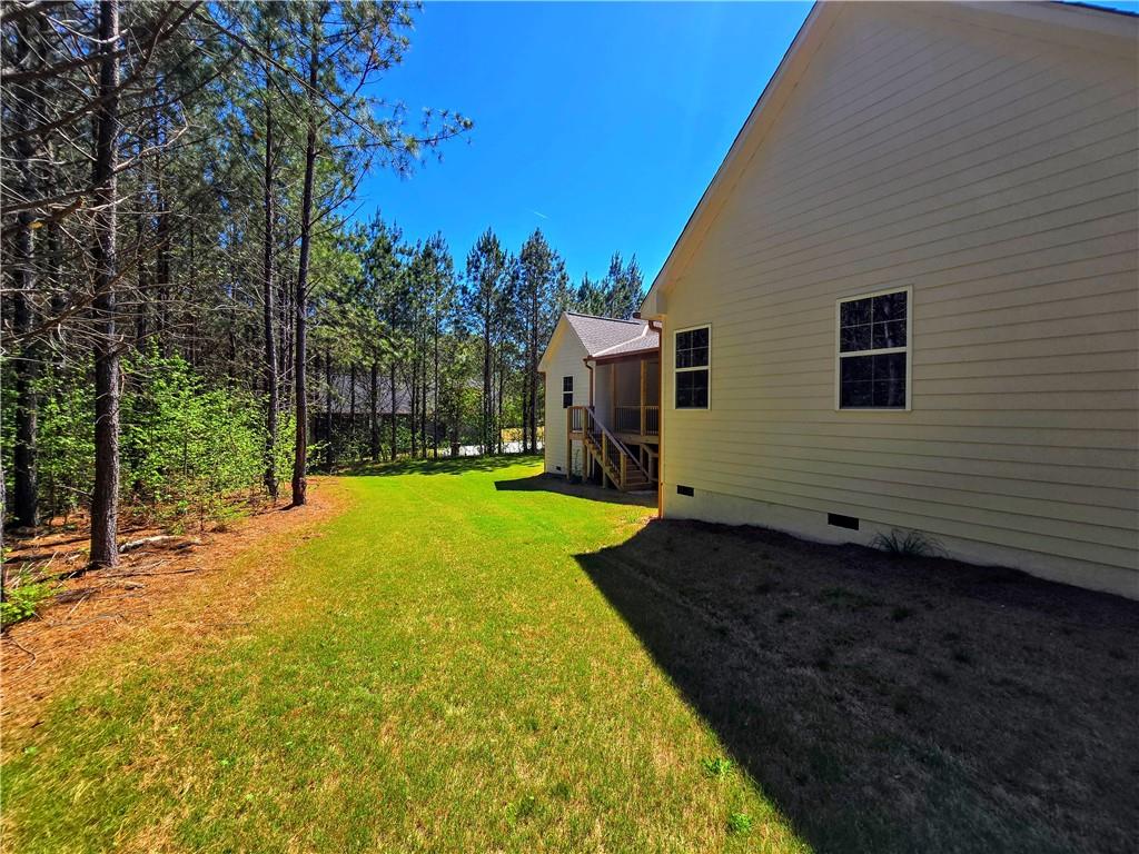 136 Rainey Road Temple, GA 30179 - Photo 62 of 75 a view of a backyard with plants and large trees
