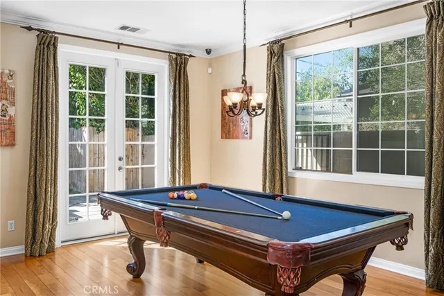 a area with pool table and windows