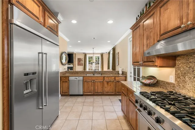 a kitchen with stainless steel appliances granite countertop a stove a sink dishwasher and refrigerator