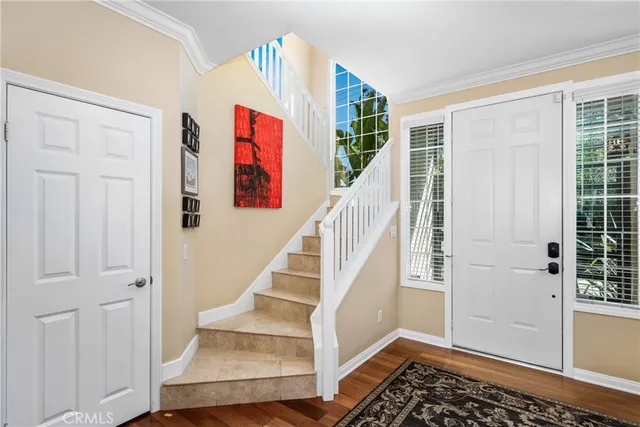a view of entryway and hall with wooden floor