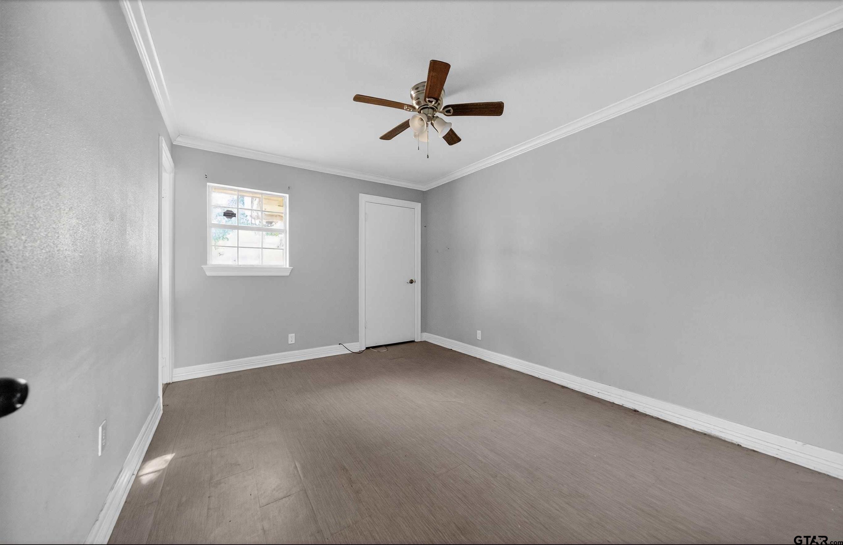3408 Jackson Avenue Tyler, TX 75705 - Photo 31 of 45 an empty room with windows and fan