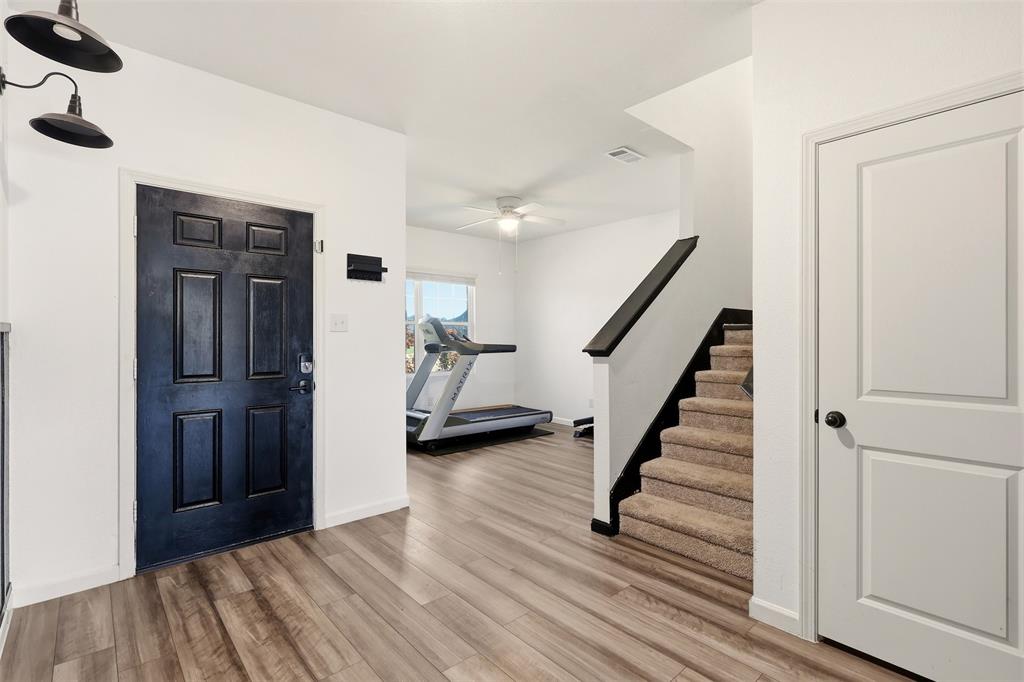 791 Devonshire Drive Lavon, TX 75166 - Photo 12 of 32 a view of a livingroom with wooden floor and stairs