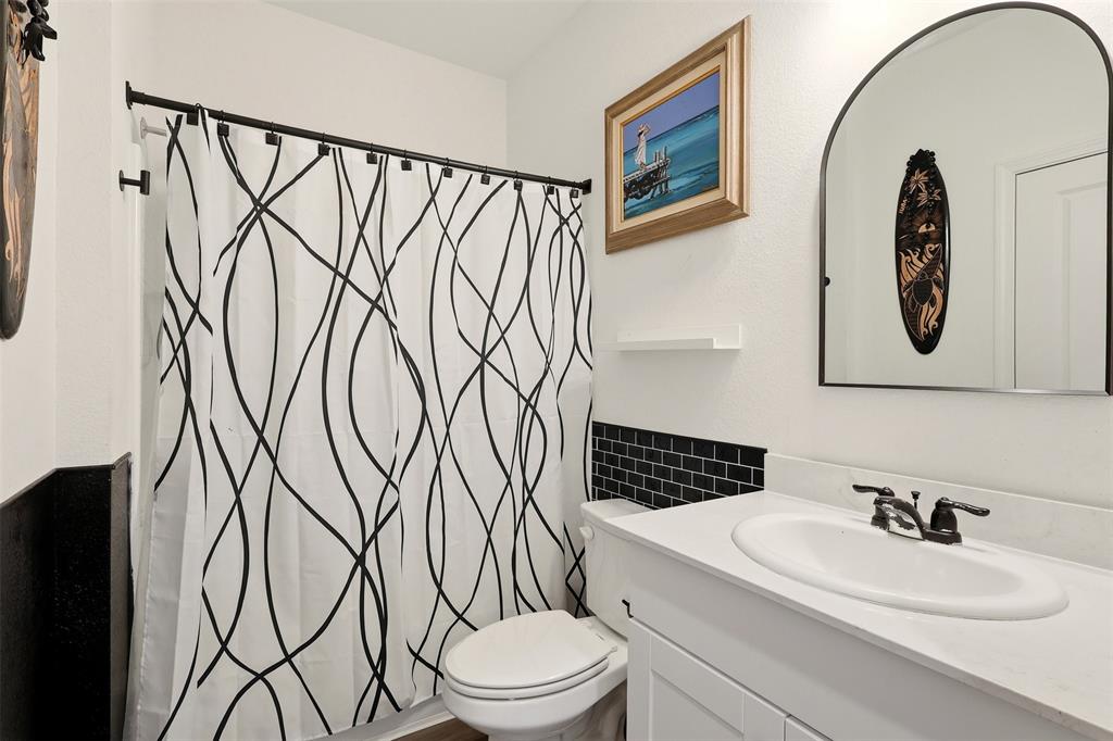 791 Devonshire Drive Lavon, TX 75166 - Photo 15 of 32 a bathroom with a toilet sink and mirror