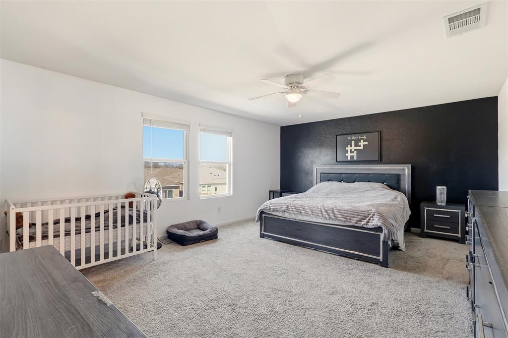 791 Devonshire Drive Lavon, TX 75166 - Photo 16 of 32 a spacious bedroom with a bed and a chandelier