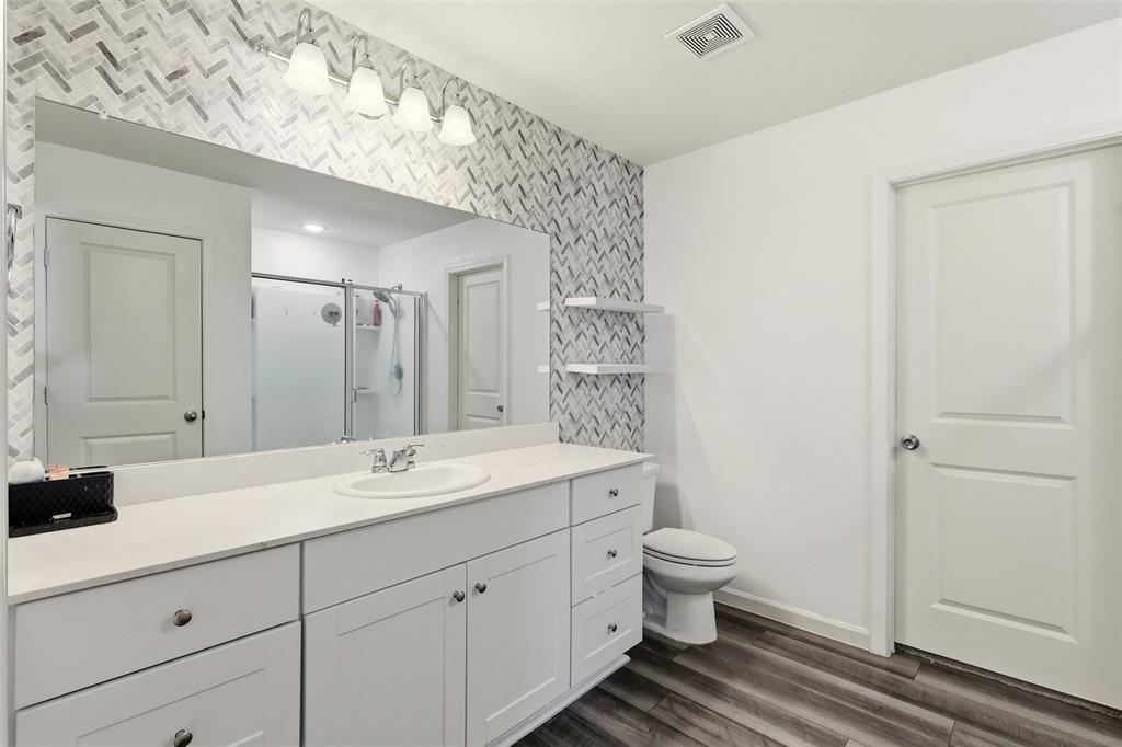 791 Devonshire Drive Lavon, TX 75166 - Photo 18 of 32 a spacious bathroom with a double vanity sink a mirror and a toilet
