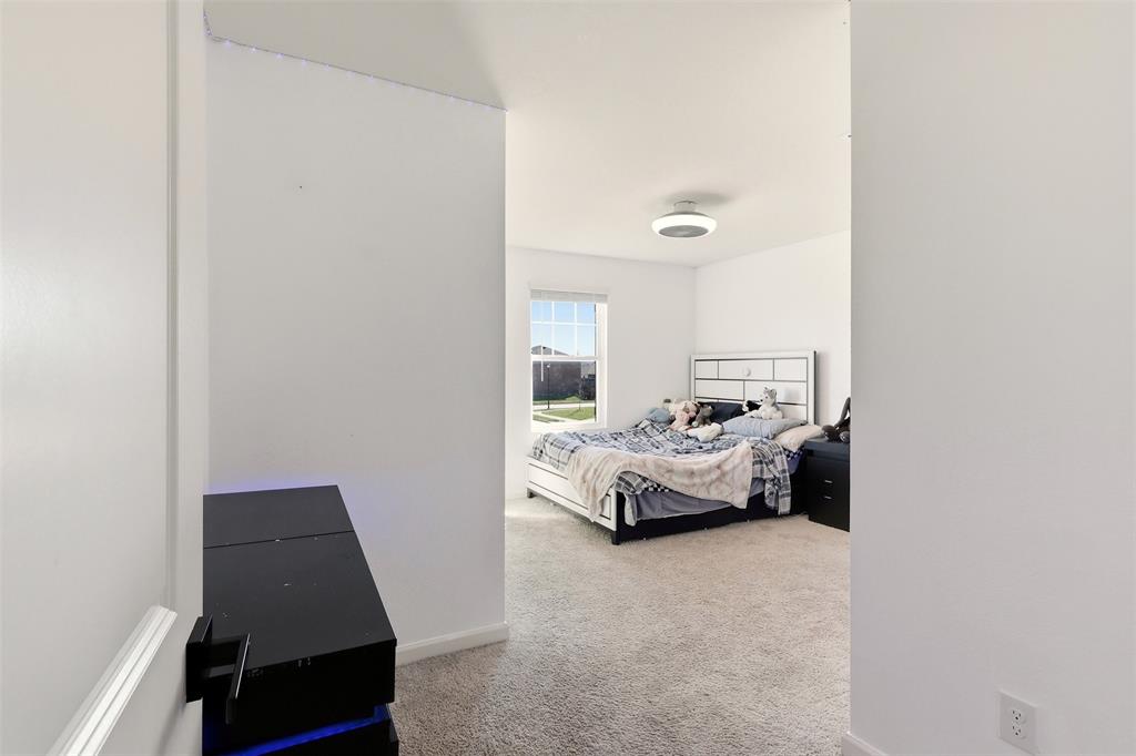 791 Devonshire Drive Lavon, TX 75166 - Photo 24 of 32 a bedroom with a bed and a window