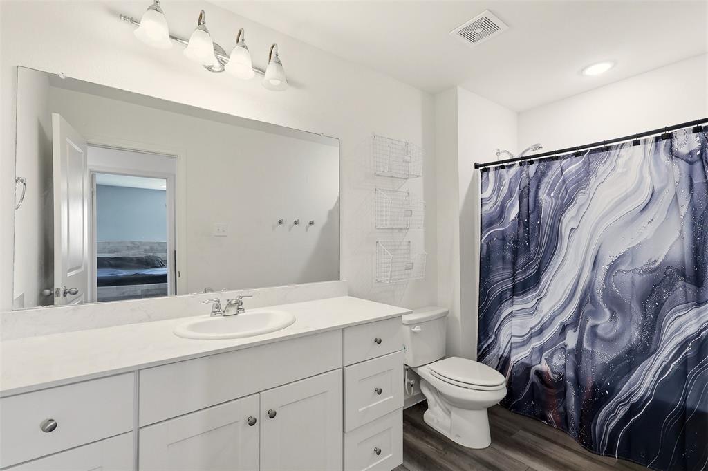 791 Devonshire Drive Lavon, TX 75166 - Photo 25 of 32 a bathroom with a sink a toilet and shower