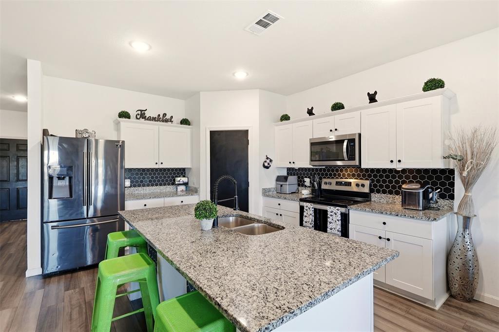 791 Devonshire Drive Lavon, TX 75166 - Photo 7 of 32 a kitchen with stainless steel appliances granite countertop a refrigerator and a stove top oven