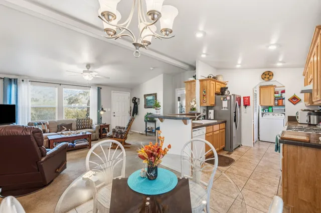 a living room with lots of furniture and kitchen view