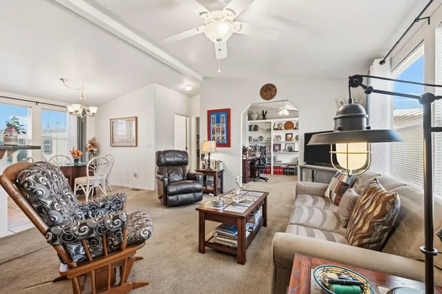 a living room with furniture a chandelier and a chandelier