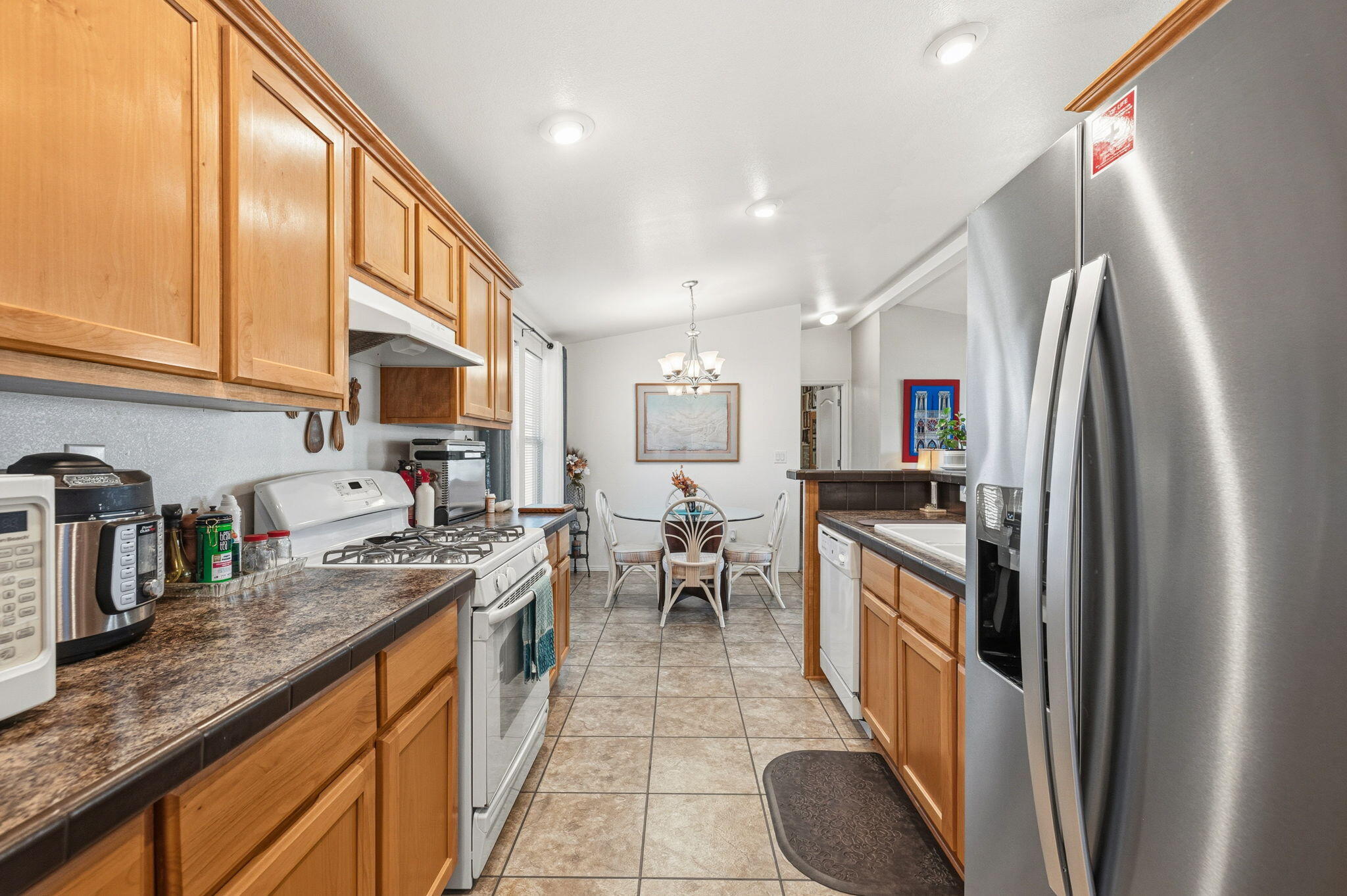 74711 Dillon Road, Unit 312 Desert Hot Springs, CA 92241 - Photo 20 of 49 a kitchen with stainless steel appliances granite countertop a sink refrigerator and cabinets